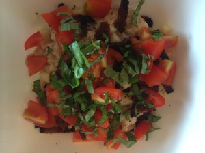 Savory oatmeal with bacon, roma tomatoes, fresh basil, chopped cheese, sea salt, cayenne and fresh cracked pepper.